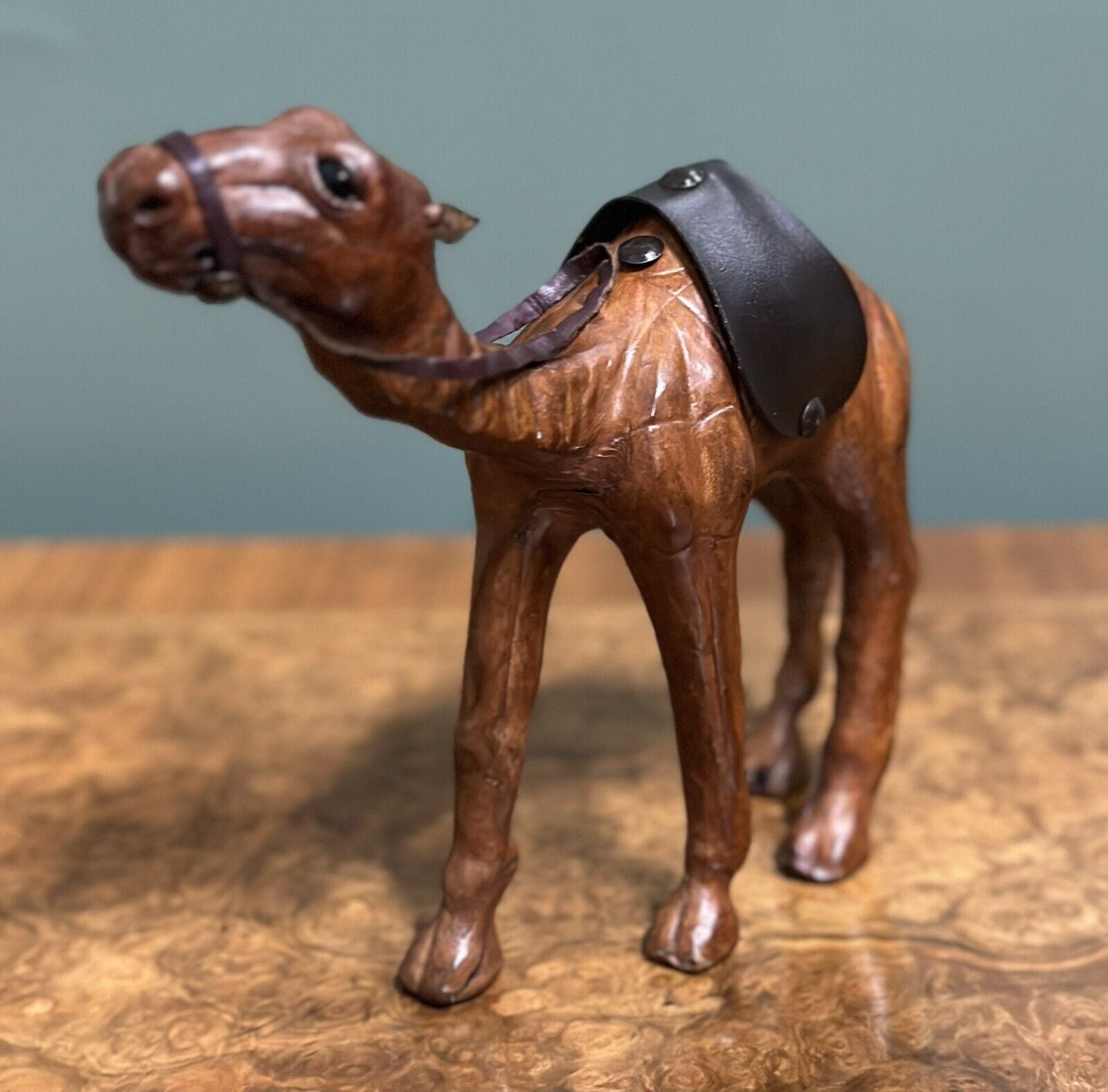 CAMEL SCULPTURE WITH LOVELY AGED LEATHER ON HAND CARVED WOOD BY LIBERTYS LONDON